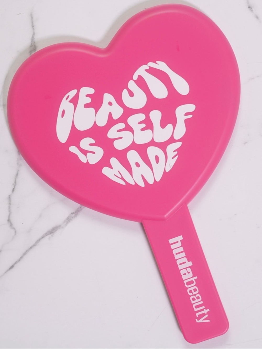 HUDA BEAUTY Heart-Shaped Hand Mirror in Bright Pink